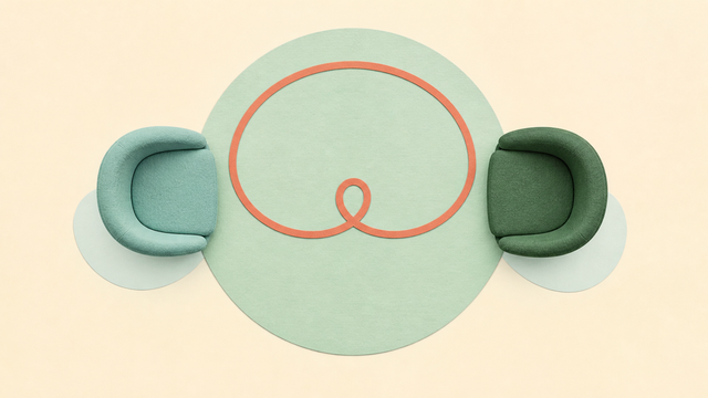 Two therapy chairs connected by a coral cord looping across the space between them.