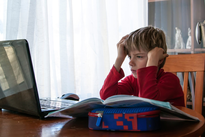 Child working one-on-one with a caring adult at a table
