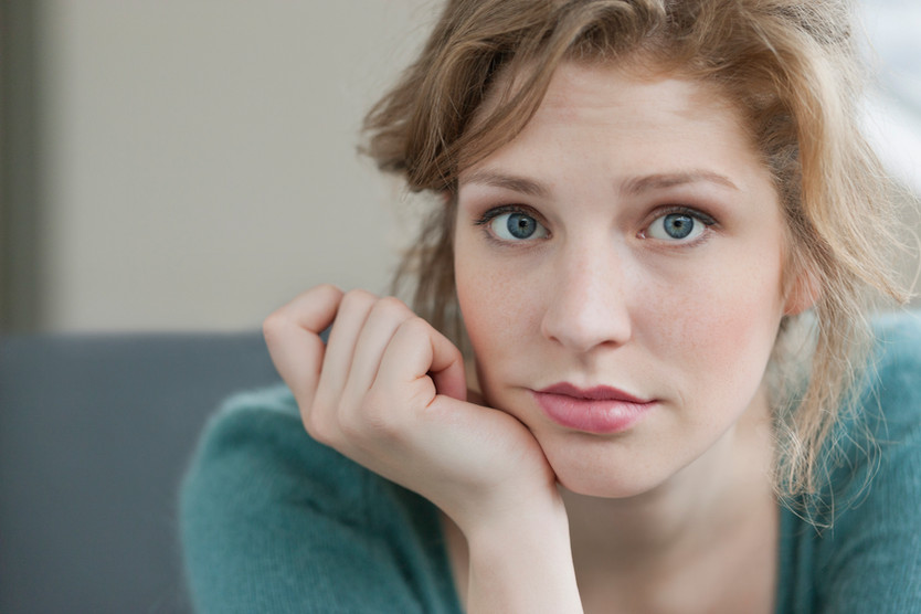 Person sitting alone looking sad and withdrawn