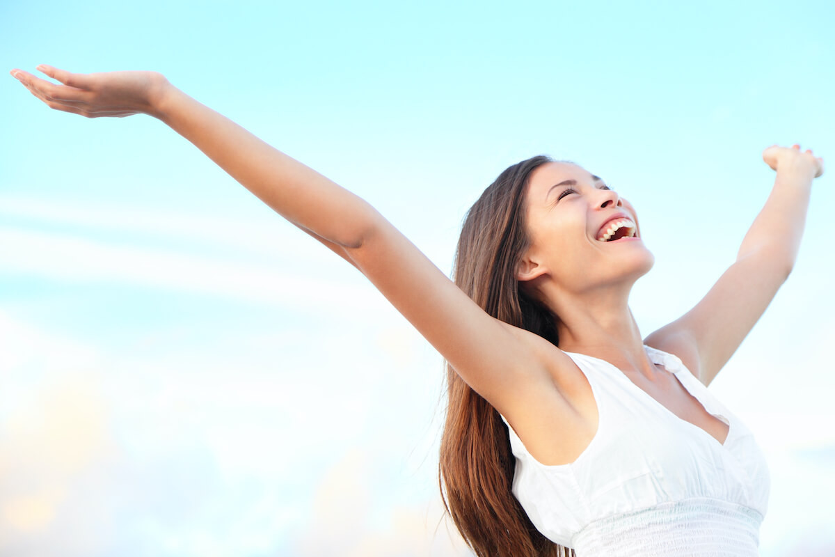 Happy woman with arms outstretched