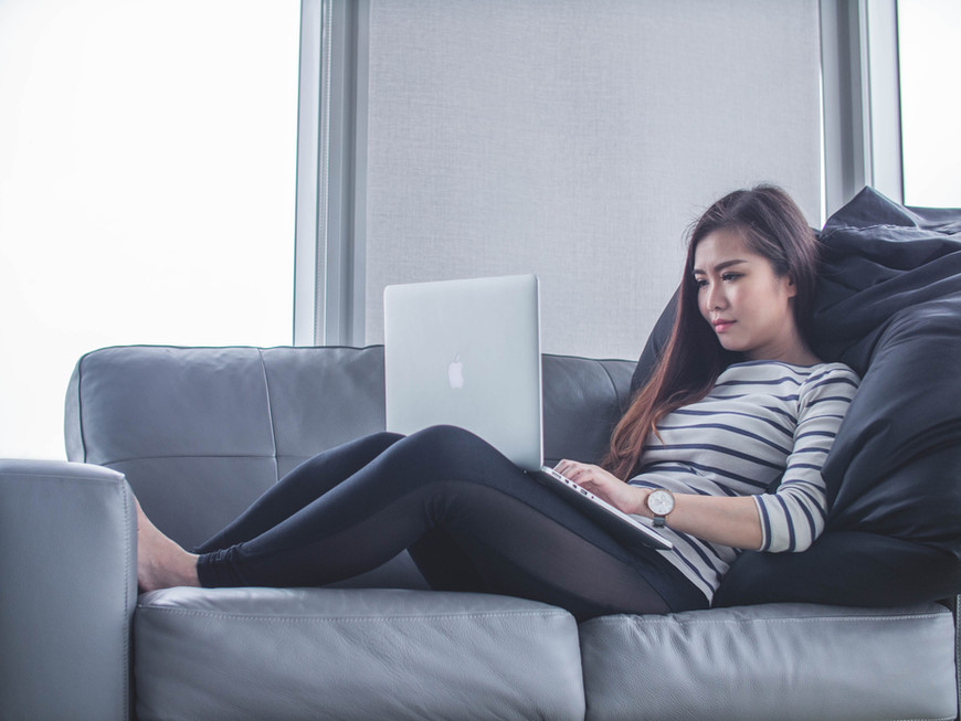 Person attending an online therapy session on a laptop